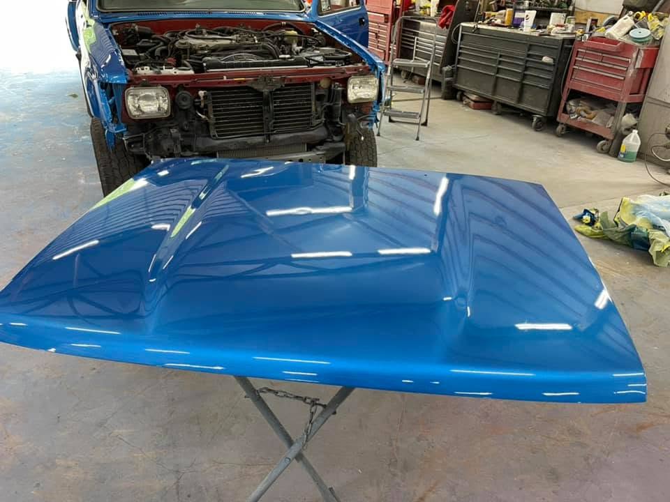 Truck engine bay open during a build at Howerton's Custom Creations
